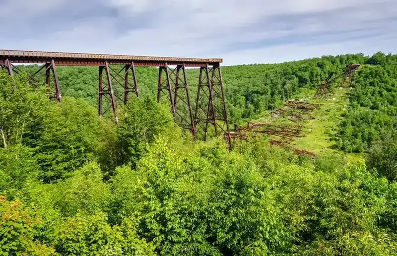 The Kinzua Sky Walk, a railroad viaduct that ends in midair, with the towers a tornado toppled lying on the slope below