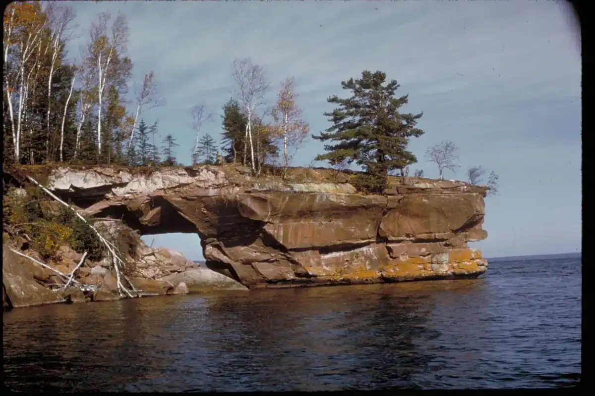 A wave-cut sandstone arch standing at the edge of Lake Superior in the Apostle Islands