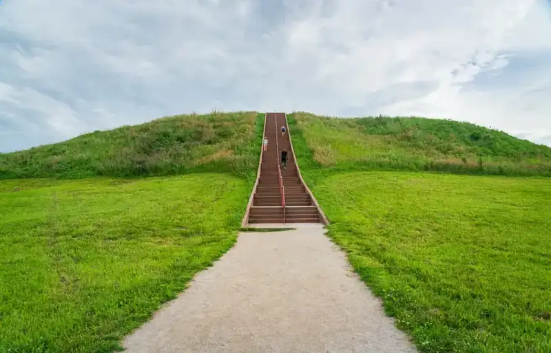 The stairway climbing the face of Monks Mound, with people on the steps