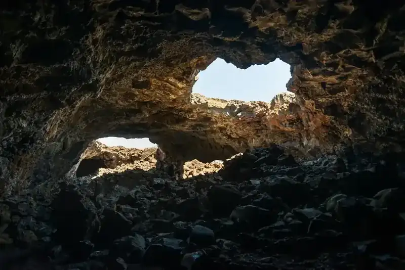 Daylight falling through collapsed openings in the roof of a lava tube cave