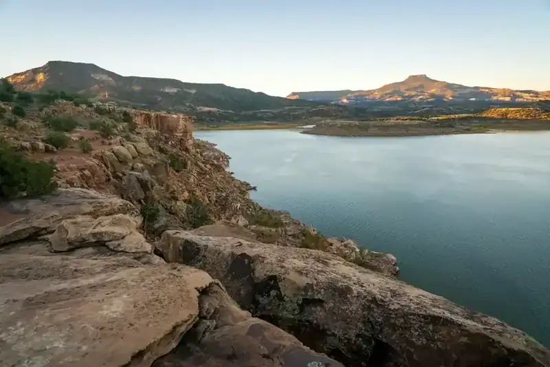 Abiquiu Lake at dusk, with Cerro Pedernal catching the last light