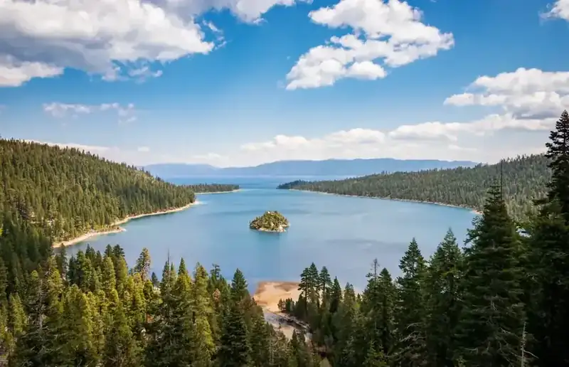 Emerald Bay and Fannette Island ringed by conifers, with Lake Tahoe beyond