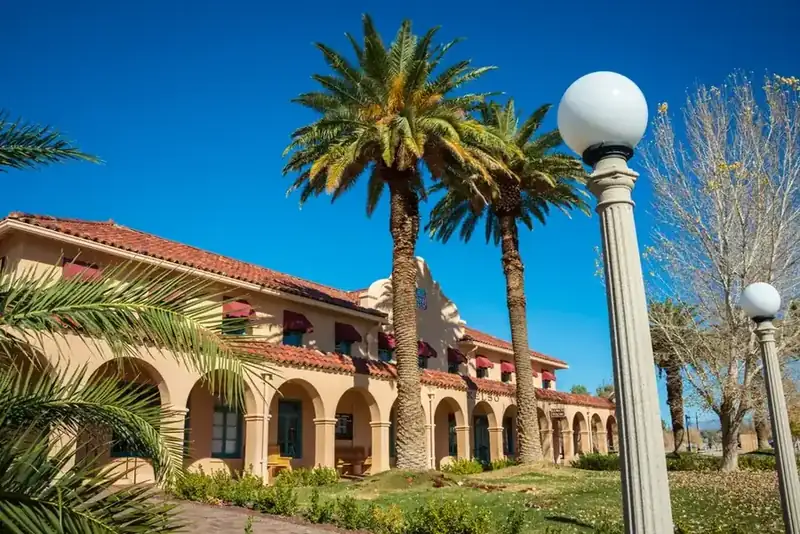 The Kelso Depot, a Spanish-style railroad station with palms, in the Mojave