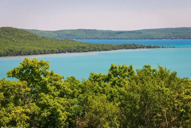 Glen Lake lying turquoise between wooded hills, seen from the heights